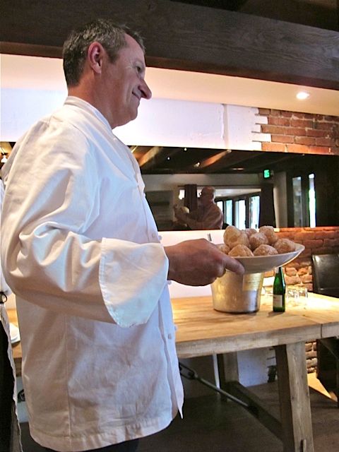 Chef-owner Gerald Hirigoyen serving his famed beignets at Piperade