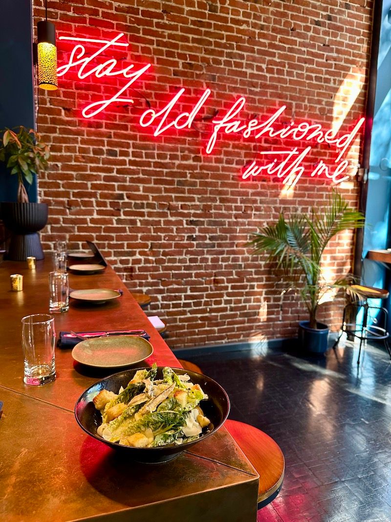 Caesar salad and the neon sign at Matty’s Old Fashioned