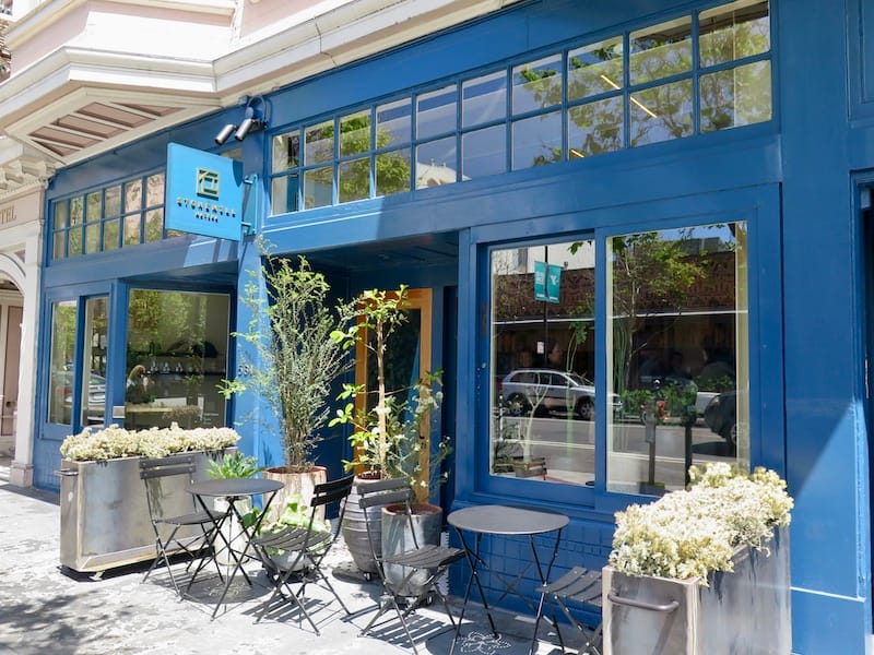 Stonemill Matcha exterior in blue with tables out front