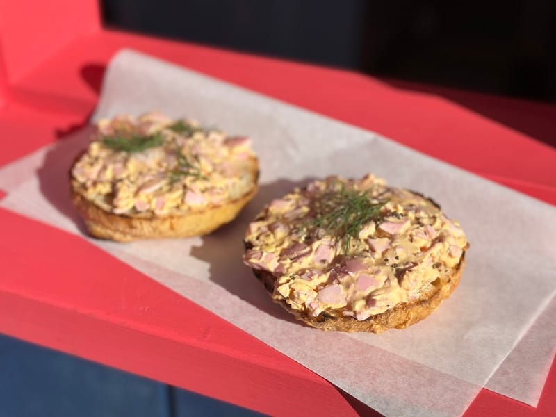 Pinky’s Egg Salad on a bagel with dill on top