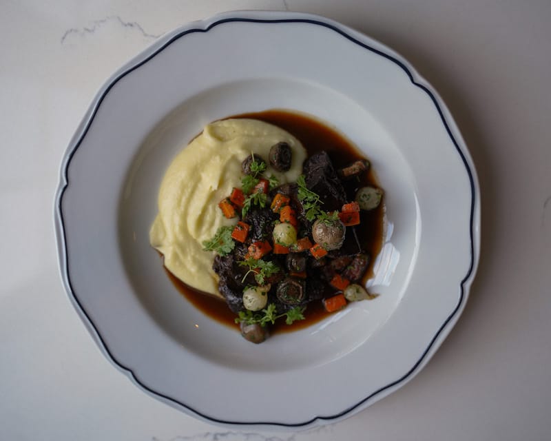 Beef cheek bourguignon is one of Augie’s featured dishes, served with pommes purée. Photo: ⓒ Avery Stark.
