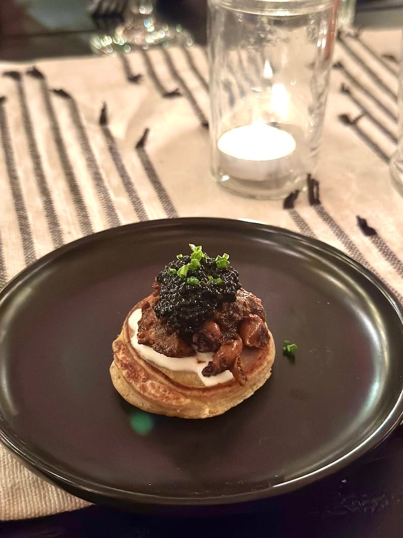 The first course at a recent e le aɖe Test Kitchen Dinner: tatale and aboboi (sweet plantain blini, stewed beans, crème fraîche, white sturgeon caviar). Photo: © tablehopper.com.