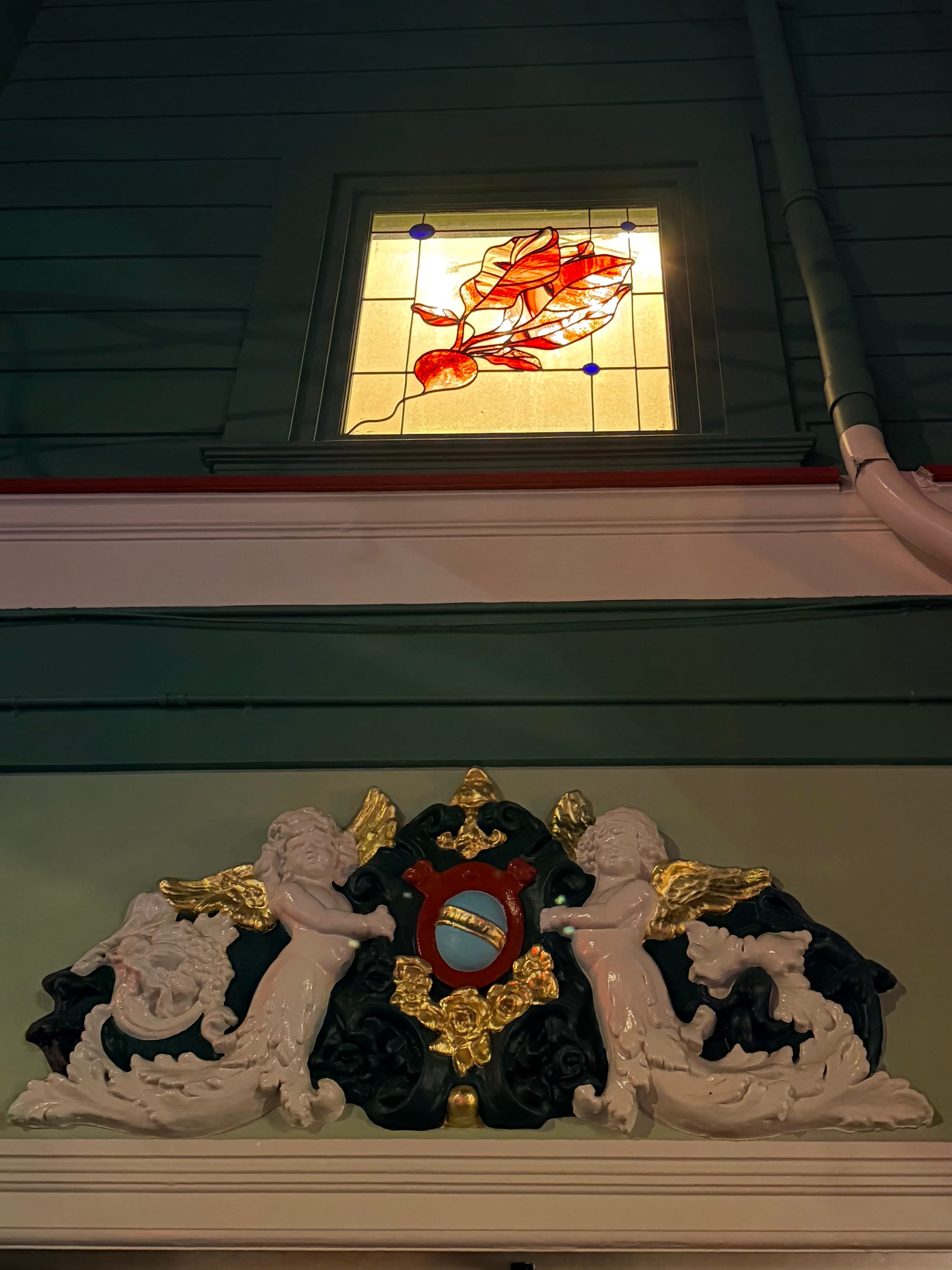 A stained glass window of the Rich’s iconic radish. Photo: © tablehopper.com.