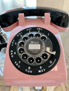 pink and black vintage dial telephone